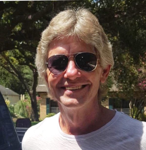 Roger Garrett smiling in aviator sunglasses